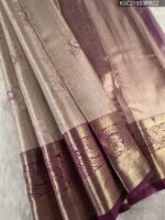 Beige Coloured Tissue Saree with Intricate Floral Motifs and Rich Zari Border