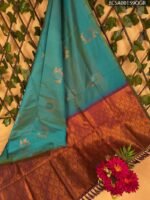 Teal and Copper Semi Soft Silk Saree with Floral Motifs and Rich Border Design
